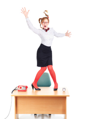 A woman frustrated from her normal desk and is ready to try a Standing Desk